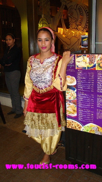 filipina waitress dressed in traditional costume outside restaurant at Robinsons Place Manila shopping mall at malate
